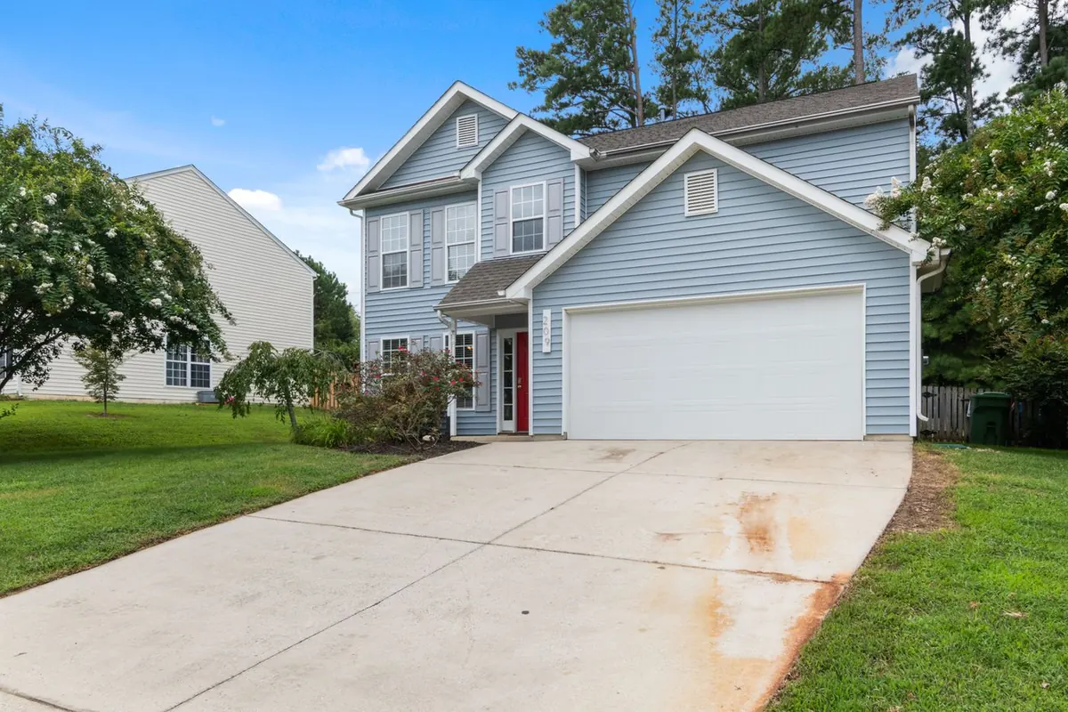 Two-story suburban house with a front garage and gutters along the roof