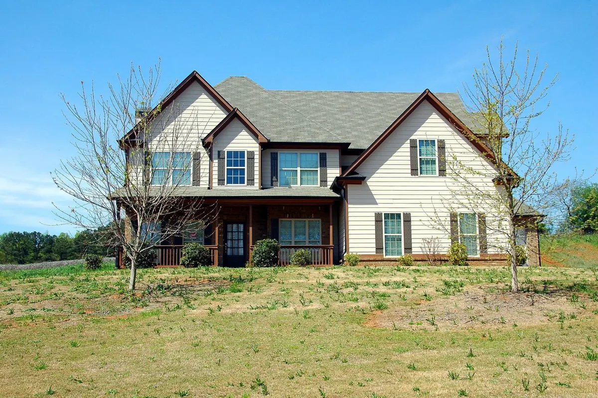Two-story house with white trim and gutters along every roof edge