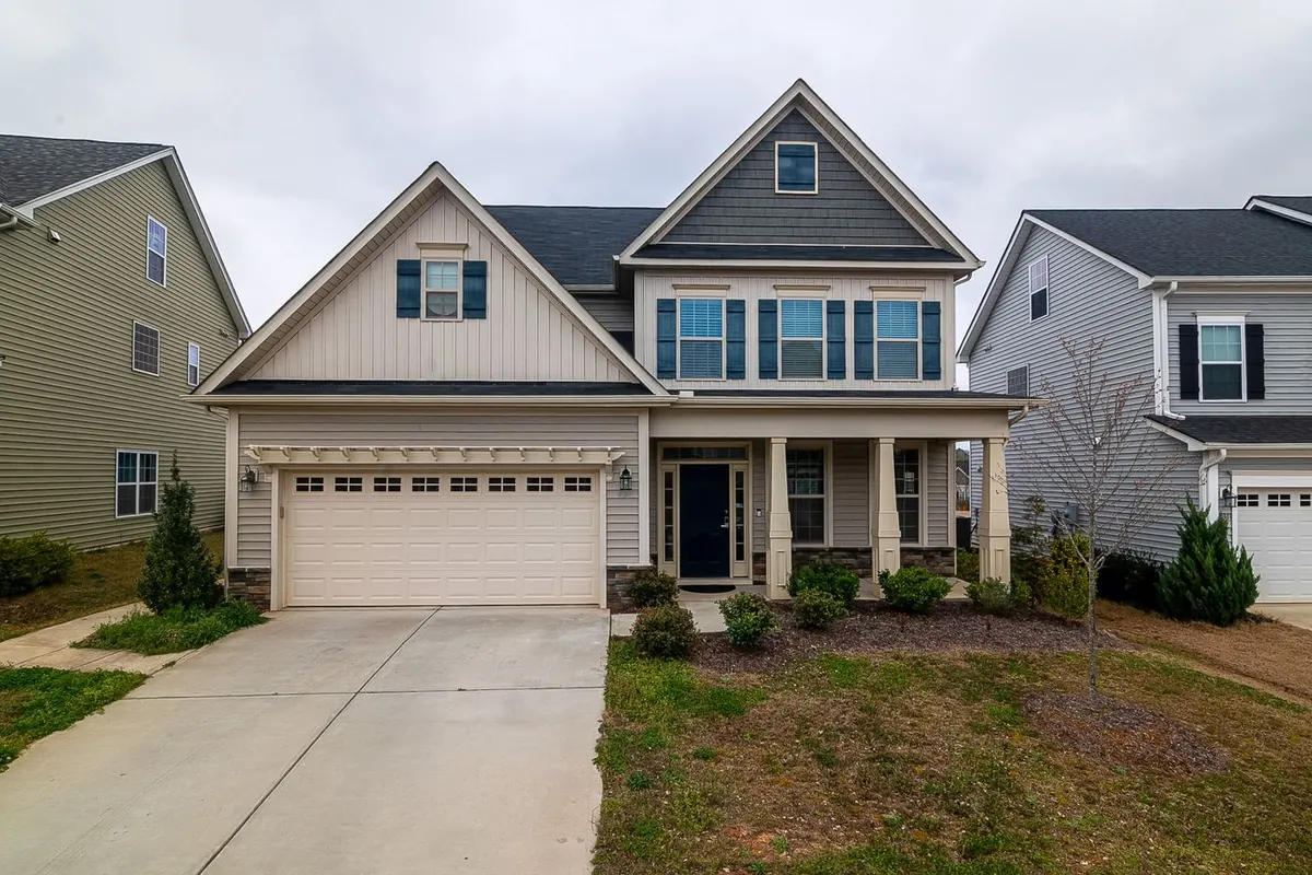 Two-story suburban home with a front-load garage and a young landscaped yard
