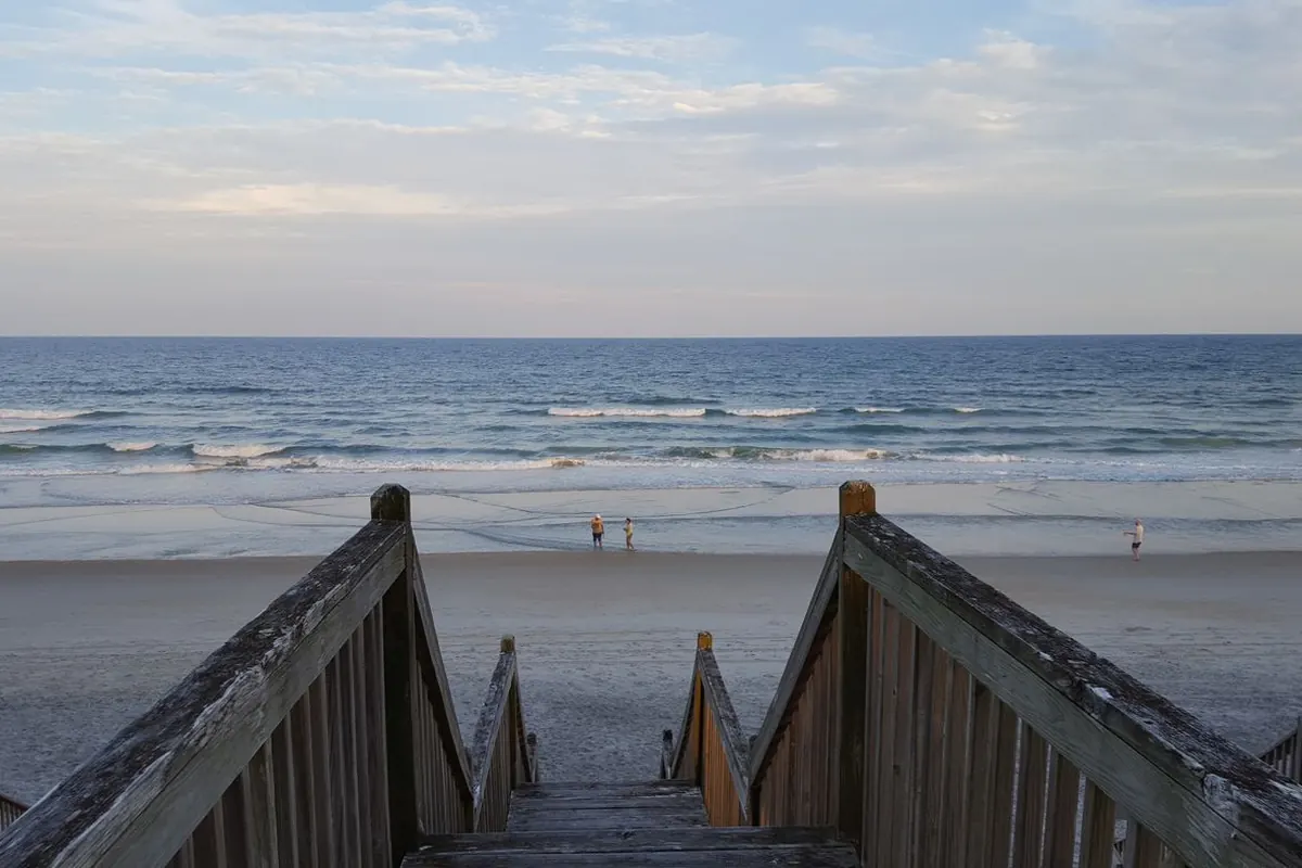 Wooden beach access stairs leading down to the ocean